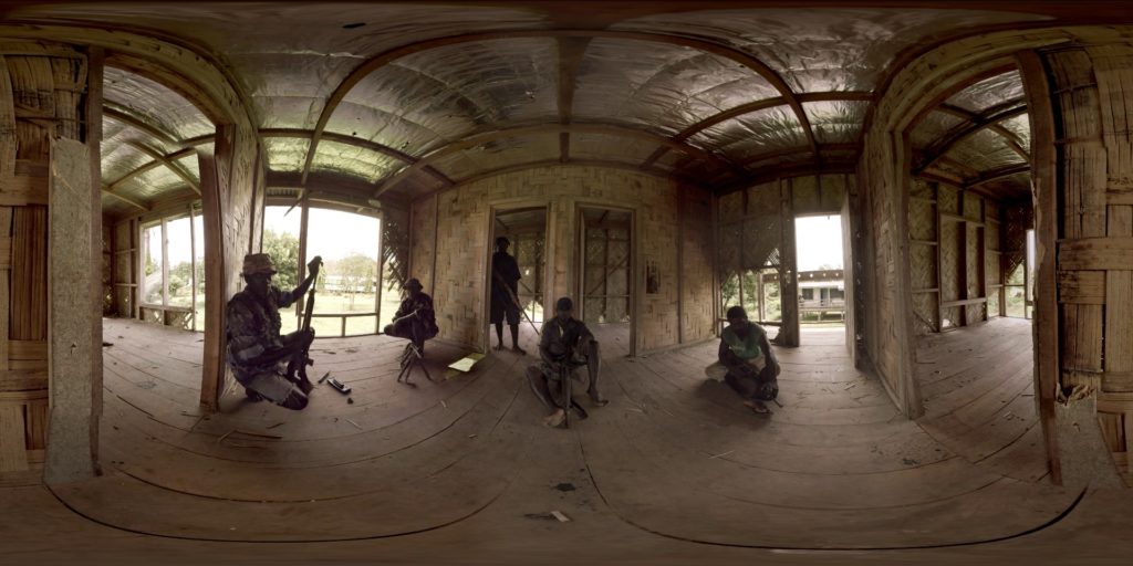 Solomon Islands residents holding automatic weapons, viewed through Virtual Reality