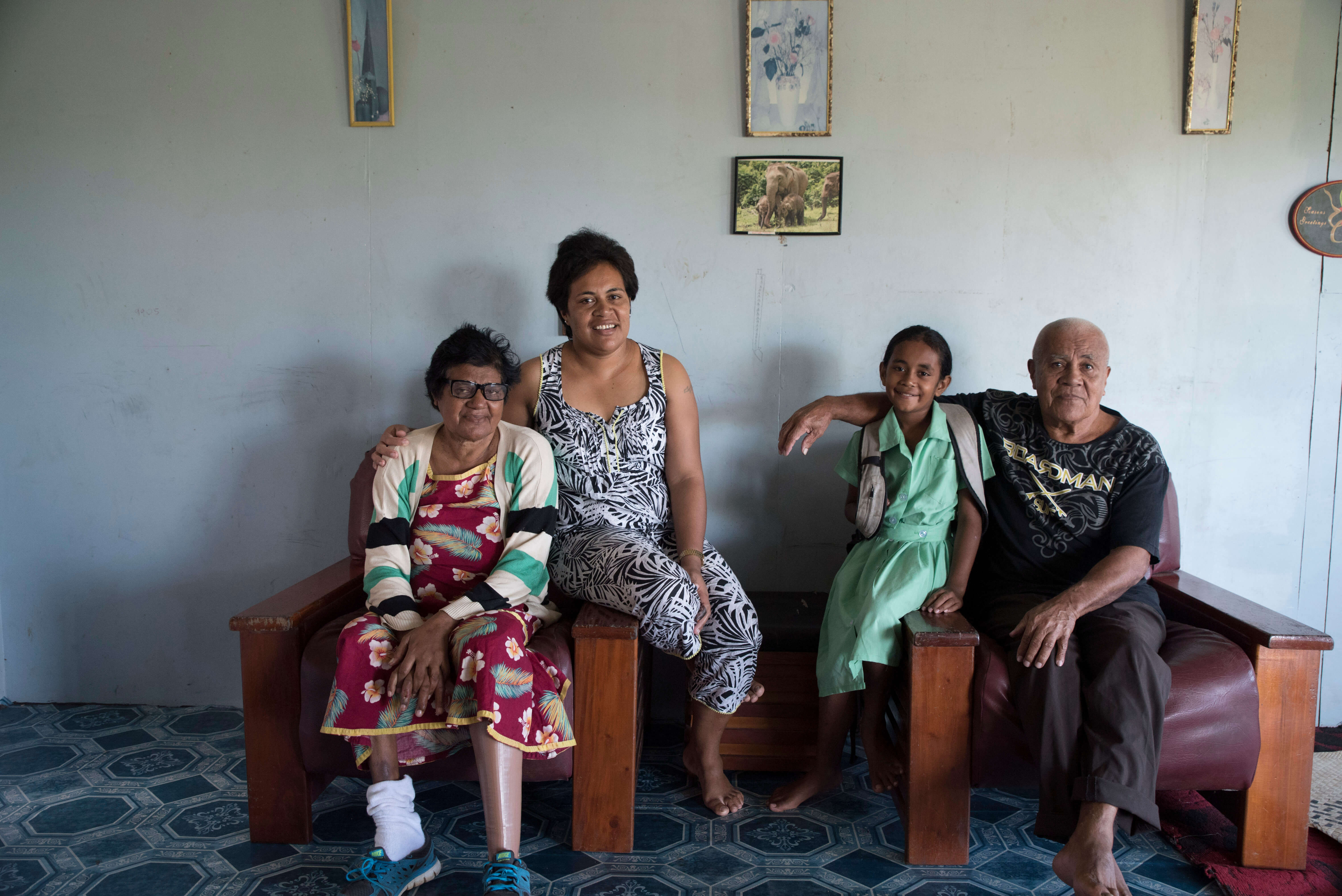 A Fijian family participating in Beyond the Stars sits for a portrait at their home in Nausori, Fiji.