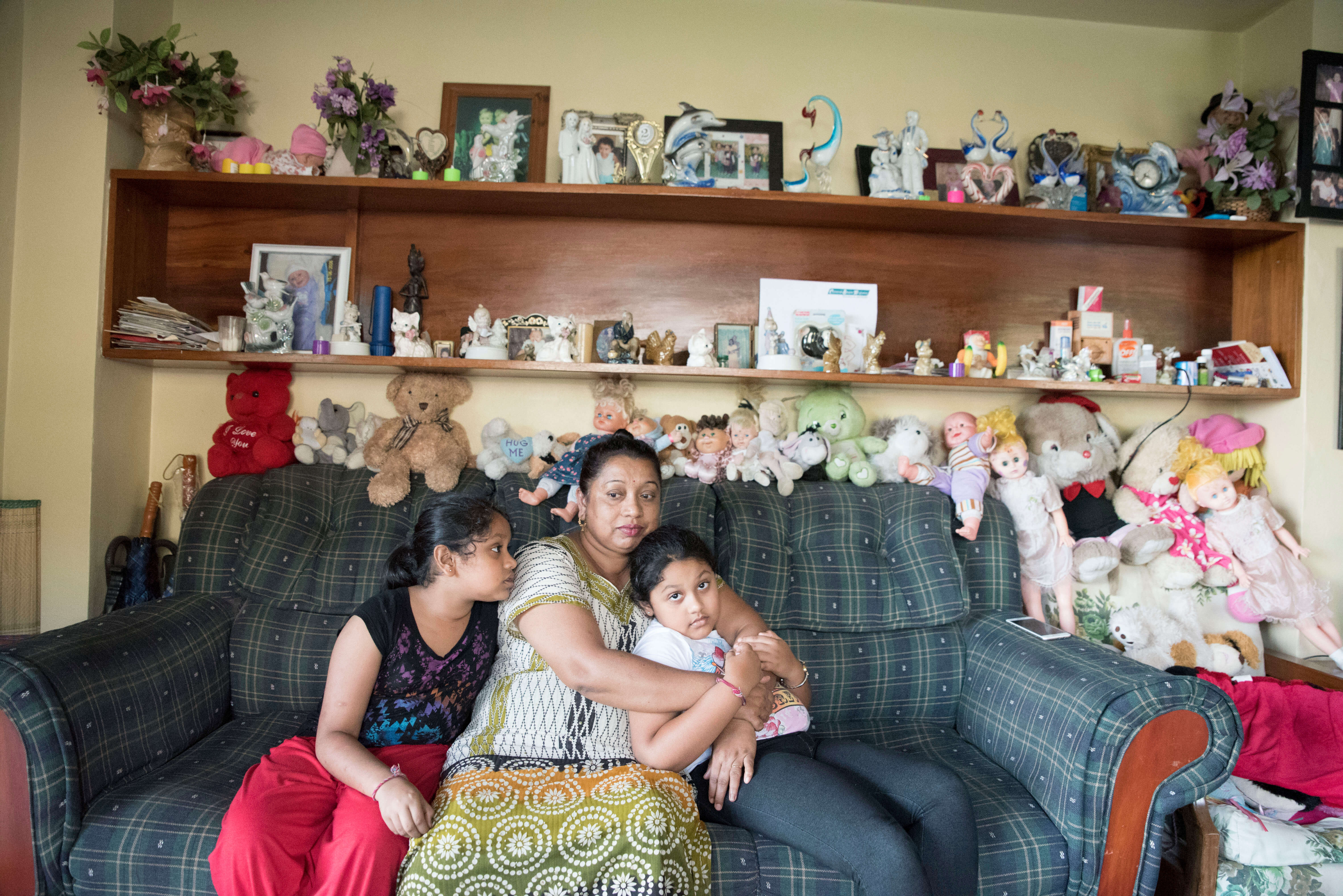 Family who used the Beyond the Stars educational pilot sits together in their home in Sigatoka, Fiji.