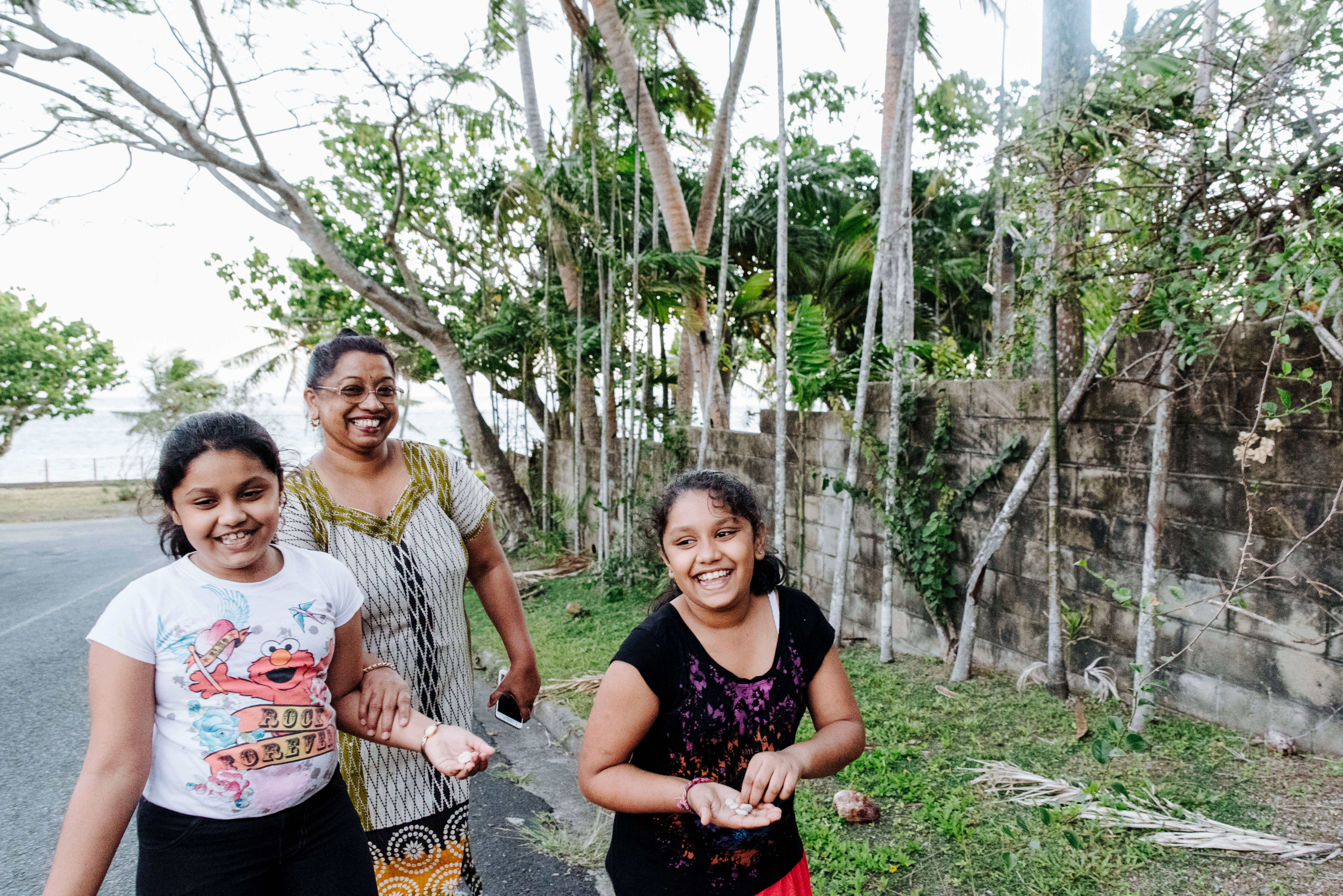A Fijian family walk home after a day at the beach in Sigatoka, Fiji.
