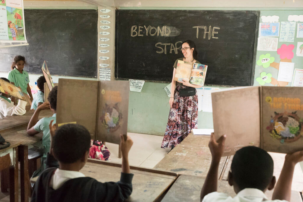 S1T2 team member works on the Beyond the Stars program with a class of Fijian children