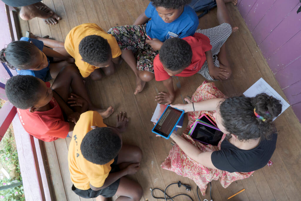 A group of Fijian children help test the Beyond the Stars Mobile game at a school in Viti Levu