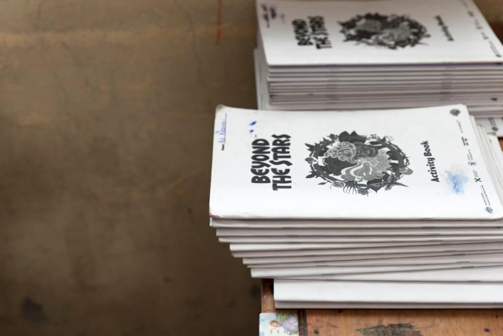 Stack of Beyond the Stars activity books at a school in Fiji