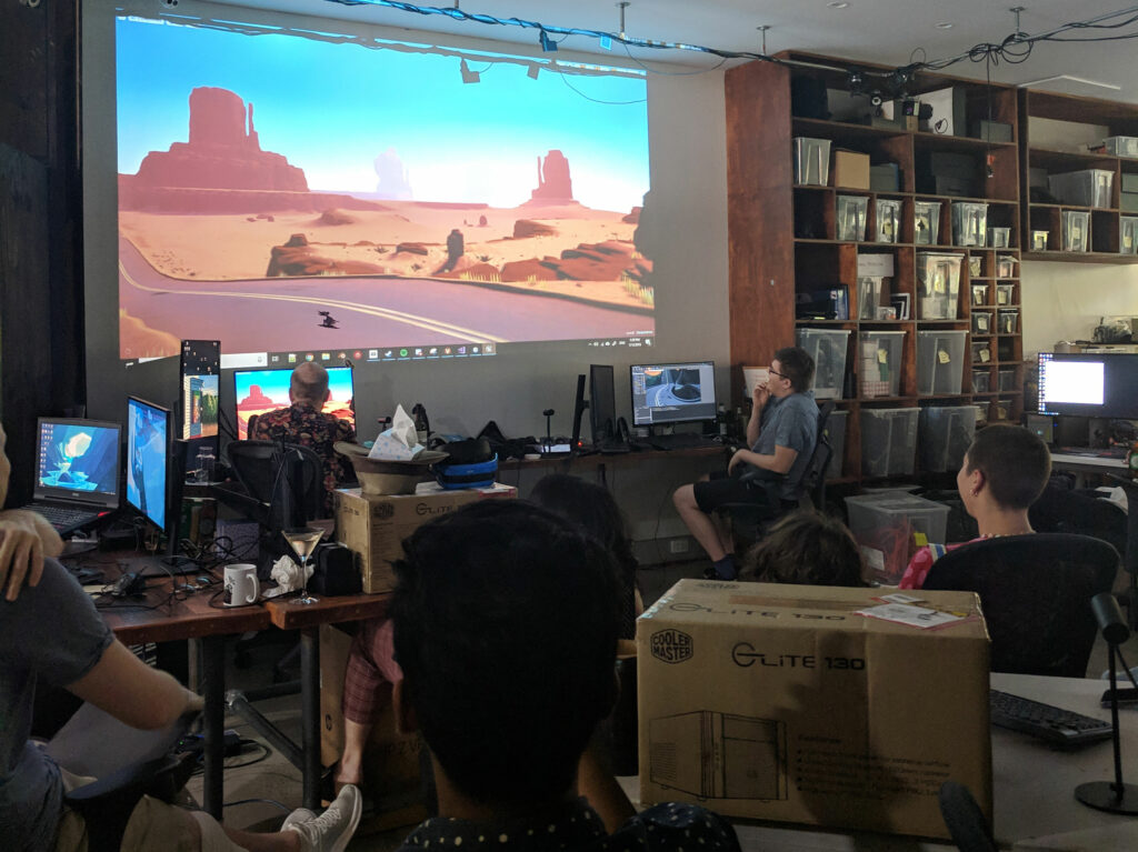 Explorer VR development team review progress on a projector