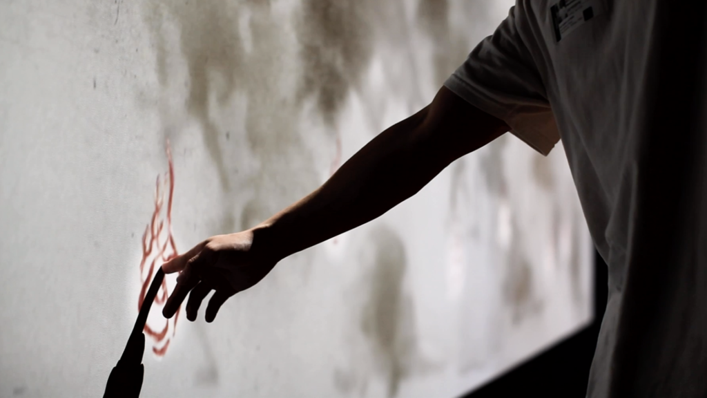Man touches a flame animated interactive touch point made with conductive ink