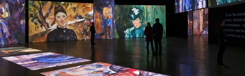 Two people admire Grande Exhibitions’ high-definition projection artworks based on the French Impressionists